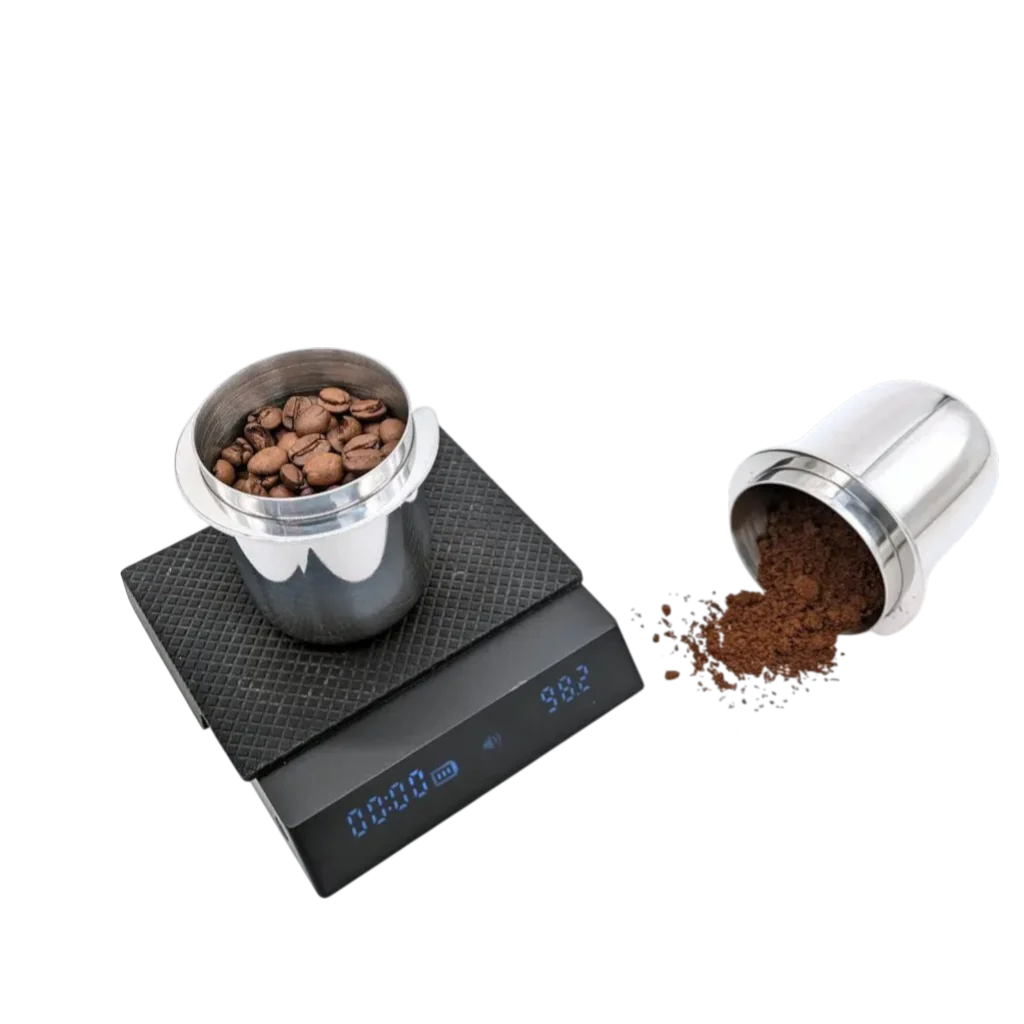 Zwei KM Messbecher 58mm, ein Messbecher ist auf einer Waage mit ganzen Kaffeebohnen, der andere liegt daneben mit bereits gemahlenem Kaffee